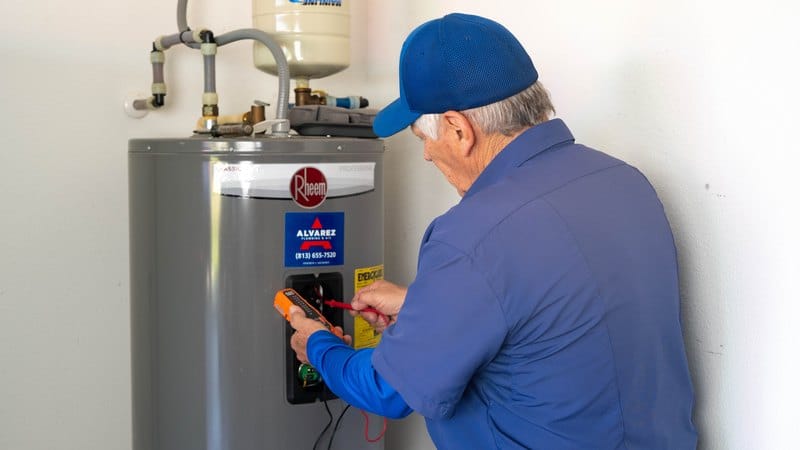 Alvarez Plumbing & AC technician testing a Rheem water heater